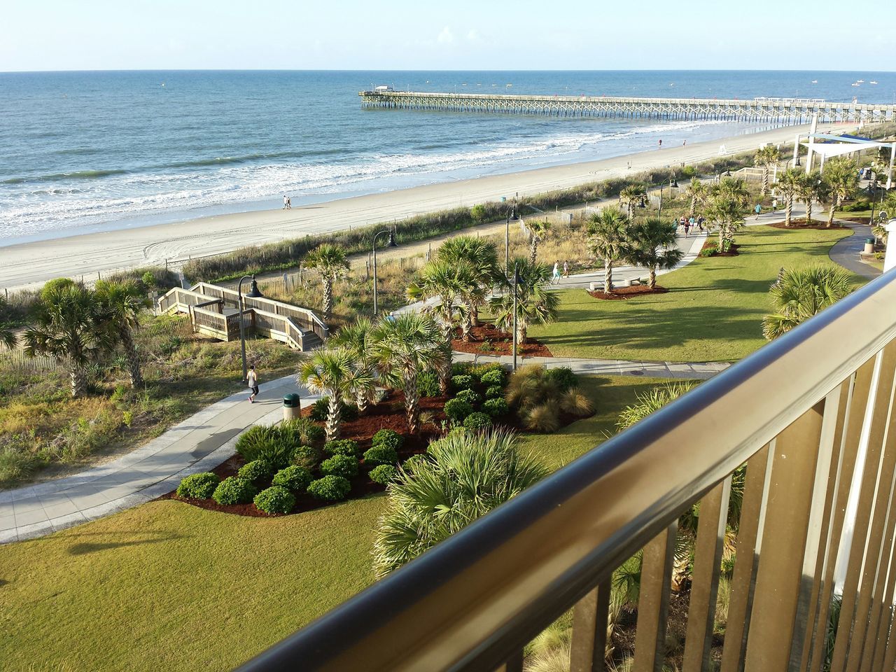 sea, horizon over water, water, beach, growth, nature, railing, shore, plant, beauty in nature, sky, scenics, high angle view, tranquil scene, tranquility, coastline, day, sand, outdoors, tree