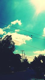 Low angle view of silhouette trees against sky