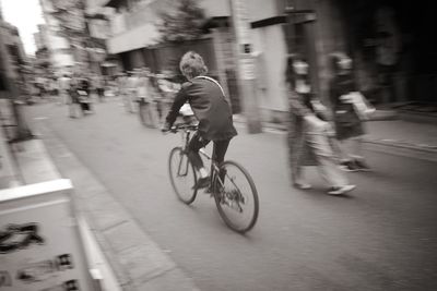 Man riding bicycle on street