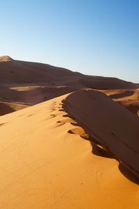 Scenic view of desert against clear sky