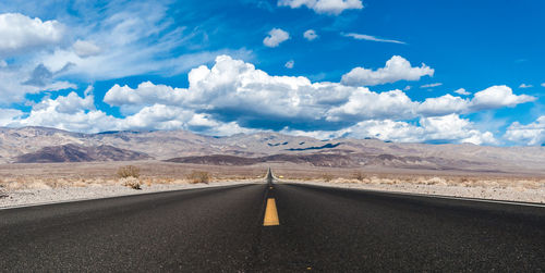 Empty road with mountain in background