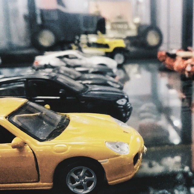 transportation, mode of transport, land vehicle, car, focus on foreground, street, close-up, part of, selective focus, yellow, travel, cropped, road, motorcycle, stationary, day, outdoors, bicycle