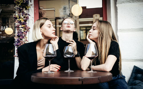 Young woman drinking glasses on table at restaurant