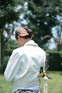 Rear view of girl with plant