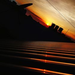Silhouette airplane against sky during sunset