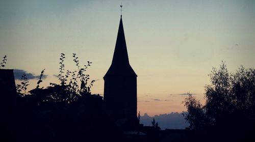 Silhouette trees against sky during sunset