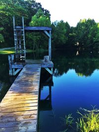 View of swimming pool by lake against sky