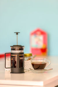 Close-up of french press coffee maker on table