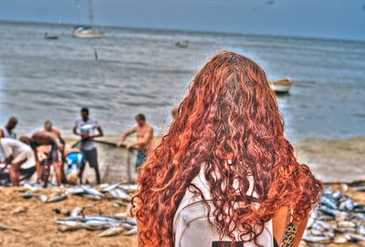 People at beach against sky