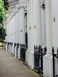 Numbers on columns by sidewalk