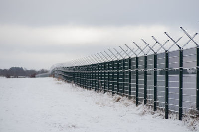 Fence against sky during winter