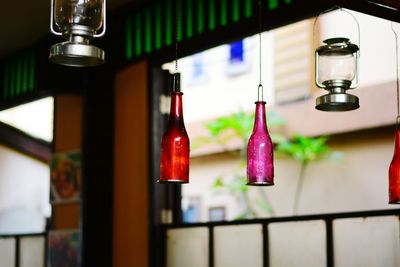 Close-up of wine bottles hanging at home