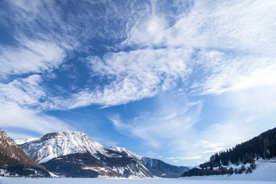 Scenic view of snow covered mountains against sky