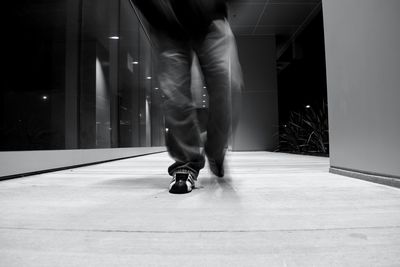 Low section of man walking against wall