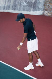 Full length of man playing tennis