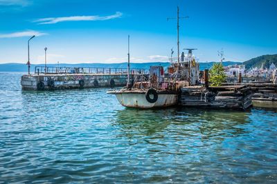 Boats moored on sea against sky