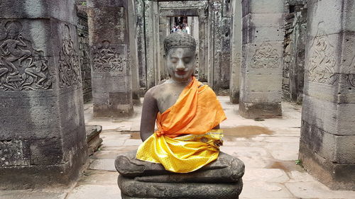 Statue of buddha against building