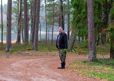 Portrait of man standing in forest