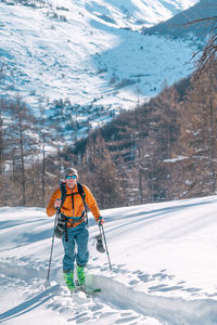 People skiing on snow covered mountain