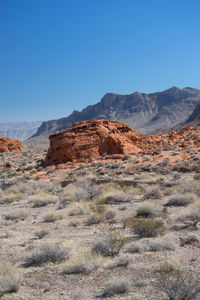 View of rock formations in desert against blue sky