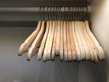 Close-up of wooden coat hangers hanging in rack