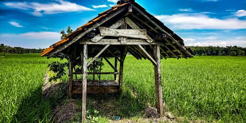 Built structure on field against sky