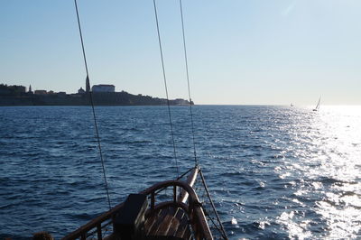 Sailboat sailing on sea against clear sky