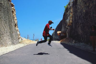 Man on road against clear sky