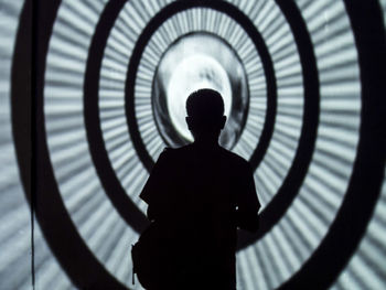 Silhouette of person standing in clock