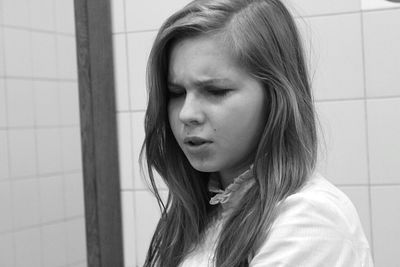 Close-up of young woman with long hair at home