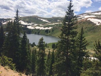 Scenic view of trees and mountains against sky