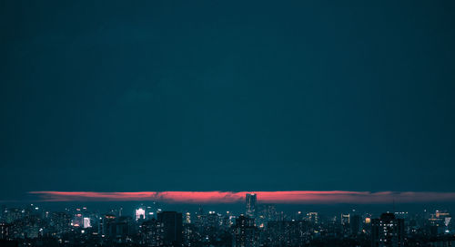 Aerial view of illuminated buildings in city at night