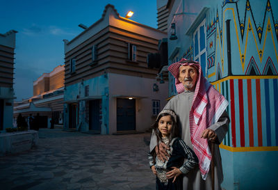 Portrait of woman standing on street in city