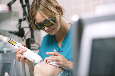 Close-up of young woman holding smart phone