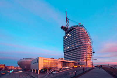 Modern buildings against blue sky at sunset