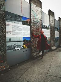 Woman with umbrella standing in city