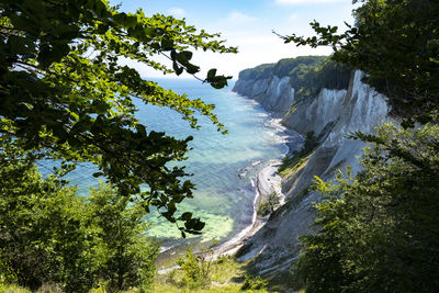 Scenic view of waterfall against sky