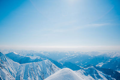 Aerial view of snow covered mountain range against sky