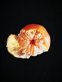 Close-up of orange fruit against black background