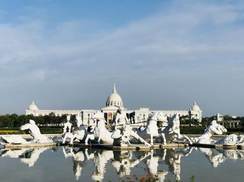 Reflection of building on water against sky