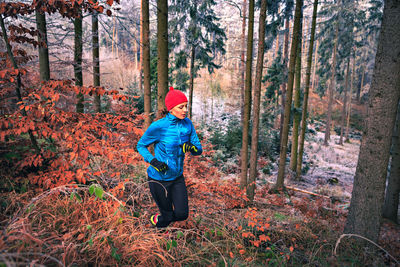 Full length of man standing in forest