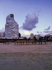 Panoramic view of beach and buildings against sky