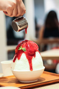 Close-up of hand holding ice cream