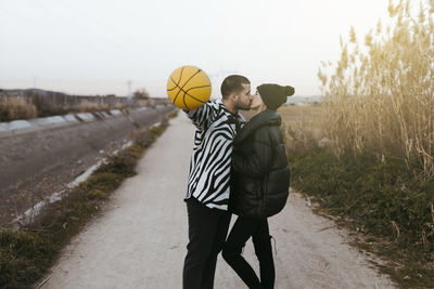 Rear view of man walking on road