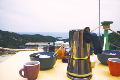 Close-up of coffee served on table against sky