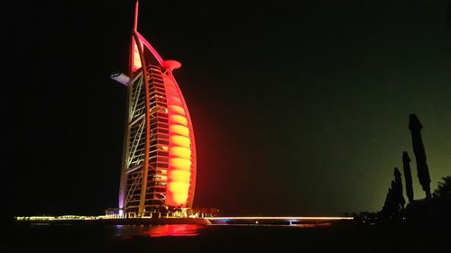 Low angle view of illuminated buildings against sky at night