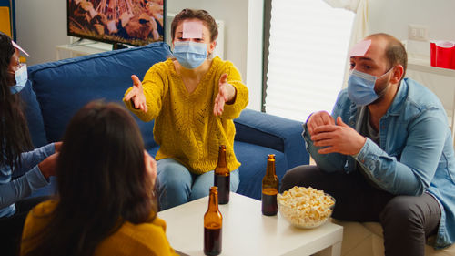 People sitting on sofa at home