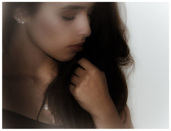 Close-up of beautiful young woman over white background