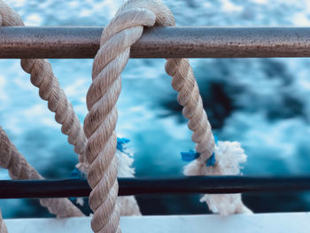 Close-up of rope tied to boat railing