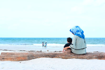 People on beach against sky